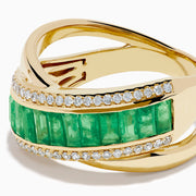 The 14K Yellow Gold Emerald and Diamond Crossover Ring features a central row of rectangular emeralds bordered by rows of sparkling white diamonds in an elegant crisscross design.