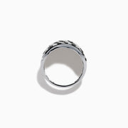 The 14K White Gold Black and White Diamond Zebra Print Ring features a wide, curved band with a striking black and white diamond stripe pattern set in sparkling white gold.