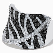 The 14K White Gold Black and White Diamond Zebra Print Ring features a wide, curved band with a striking black and white diamond stripe pattern set in sparkling white gold.