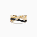 The 14K Yellow Gold Black and White Diamond Crossover Ring features three intertwined bands: a polished gold band, a black and white diamond band, and a clear diamond wave-patterned band.