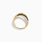 The 14K Yellow Gold Black and White Diamond Crossover Ring features three intertwined bands: a polished gold band, a black and white diamond band, and a clear diamond wave-patterned band.