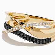 The 14K Yellow Gold Black and White Diamond Crossover Ring features three intertwined bands: a polished gold band, a black and white diamond band, and a clear diamond wave-patterned band.