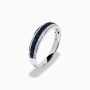 The 14K White Gold Pave Blue Sapphire and Diamond Band features a central row of blue sapphires bordered by sparkling diamonds, displayed on a plain white background.