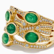 The 14K Yellow Gold Bezel Emerald and Diamond Multi Row Ring features five round green emeralds set in separate bands, accented with white diamonds and intricate detailing for a striking design.