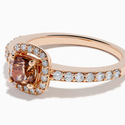 The Espresso 14K Rose Gold Brown and White Diamond Ring showcases a cushion-cut brown center stone, surrounded by a halo of white diamonds with extra diamonds adorning the band.