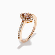 The 14K Rose Gold Brown and White Diamond Halo Ring showcases an oval brown and white diamond center, encircled by a halo of white diamonds and set with additional diamonds along the band.