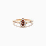The 14K Rose Gold Brown and White Diamond Marquise Halo Ring features a marquise-cut brown and white diamond centerpiece, accented by round diamonds in a halo and along the band.