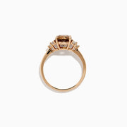 The 14K Rose Gold Cushion Cut Brown and White Diamond Ring features a central cushion-cut brown and white diamond with three small white diamonds on each side, all set in rose gold against a white background.