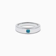 The Men's 14K White Gold Blue Diamond Ring showcases a single round blue diamond set into a sleek white gold band, shown on a plain white background.