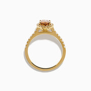 The Espresso 14K Yellow Gold Brown Diamond Halo Ring showcases an oval brown diamond center, encircled by a halo of white diamonds with additional diamonds set along the band.