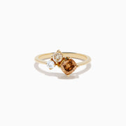 The Espresso 14K Yellow Gold Brown and White Diamond Ring showcases a round white diamond, a pear-shaped light brown diamond, and a cushion-cut brown diamond in a minimalist design against a white background.