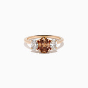 A close-up of the 14K Rose Gold Brown and White Diamond 3 Stone Ring, showcasing its beautiful brown and white diamonds in an elegant setting.