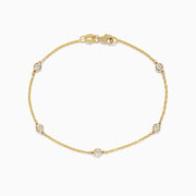 The DOro 14K Gold Diamond Station Necklace and Bracelet Set (0.59 TCW) features evenly spaced round diamonds on delicate chains, beautifully displayed on a white background.