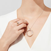 The Trio 14K Tri-Color Gold Diamond Circles Pendant (0.30 TCW) features three interlocking rings in silver, rose, and yellow gold tones with sparkling diamonds, all on a delicate silver chain.