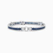 The Royale Bleu 14K White Gold Sapphire and Diamond Bracelet, 7.66 TCW, showcases square blue sapphires bordered by round diamonds and a diamond-encrusted clasp, all displayed on a plain white background.