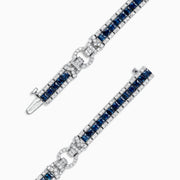 The Royale Bleu 14K White Gold Sapphire and Diamond Bracelet, 7.66 TCW, showcases square blue sapphires bordered by round diamonds and a diamond-encrusted clasp, all displayed on a plain white background.