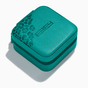 The Faux Leather Jewelry Travel Case is a square teal case with a textured leopard print accent on one corner and EFFY embossed on the lid. It features a zipper closure and is shown on a light background with a soft shadow.
