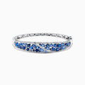 The 14K White Gold Natural Blue Sapphire & Diamond Bangle (7.82 TCW) features an intricate lattice design with clusters of round blue sapphires and sparkling diamonds along the front.