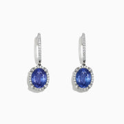 Elegant 14K white gold earrings featuring oval tanzanite gemstones and sparkling diamonds, totaling 4.14 TCW, with additional diamonds along the hooks.