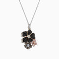 A Nature 14K Tri Color Gold Diamond Hibiscus Pendant (1.36 TCW) on a silver chain, with three jeweled flowers—two black with white centers and one smaller pink with a white center—set against a white background.