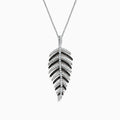 A 14K white gold pendant with .89 TCW black and white diamonds, arranged along leaf-shaped veins, hangs from a thin chain—reminiscent of Effy’s style—shown against a white background.