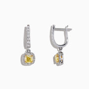 The Canare 18K Two-Tone Cushion Cut Yellow Diamond Drop Earrings (1.06 TCW) feature square yellow diamonds surrounded by clear stones, set in silver with extra clear stones along the drop. Displayed on a white background.