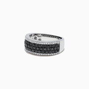 The 14K White Gold Black and White Diamond Ring, 1.28 TCW, features three rows of round black stones in the center, bordered on top and bottom by single rows of sparkling white diamonds.