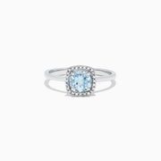 The Aquarius 14K White Gold Aquamarine and Diamond Ring, 0.78 TCW, features a cushion-cut aquamarine center with a diamond halo, shown on a white background.