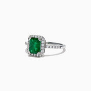The Brasilica 14K White Gold Emerald and Diamond Ring, 1.69 TCW, features a rectangular green emerald center stone with a halo of round diamonds and additional diamonds on the band, shown against a white background.
