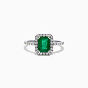 The Brasilica 14K White Gold Emerald and Diamond Ring, 1.69 TCW, features a rectangular green emerald center stone with a halo of round diamonds and additional diamonds on the band, shown against a white background.