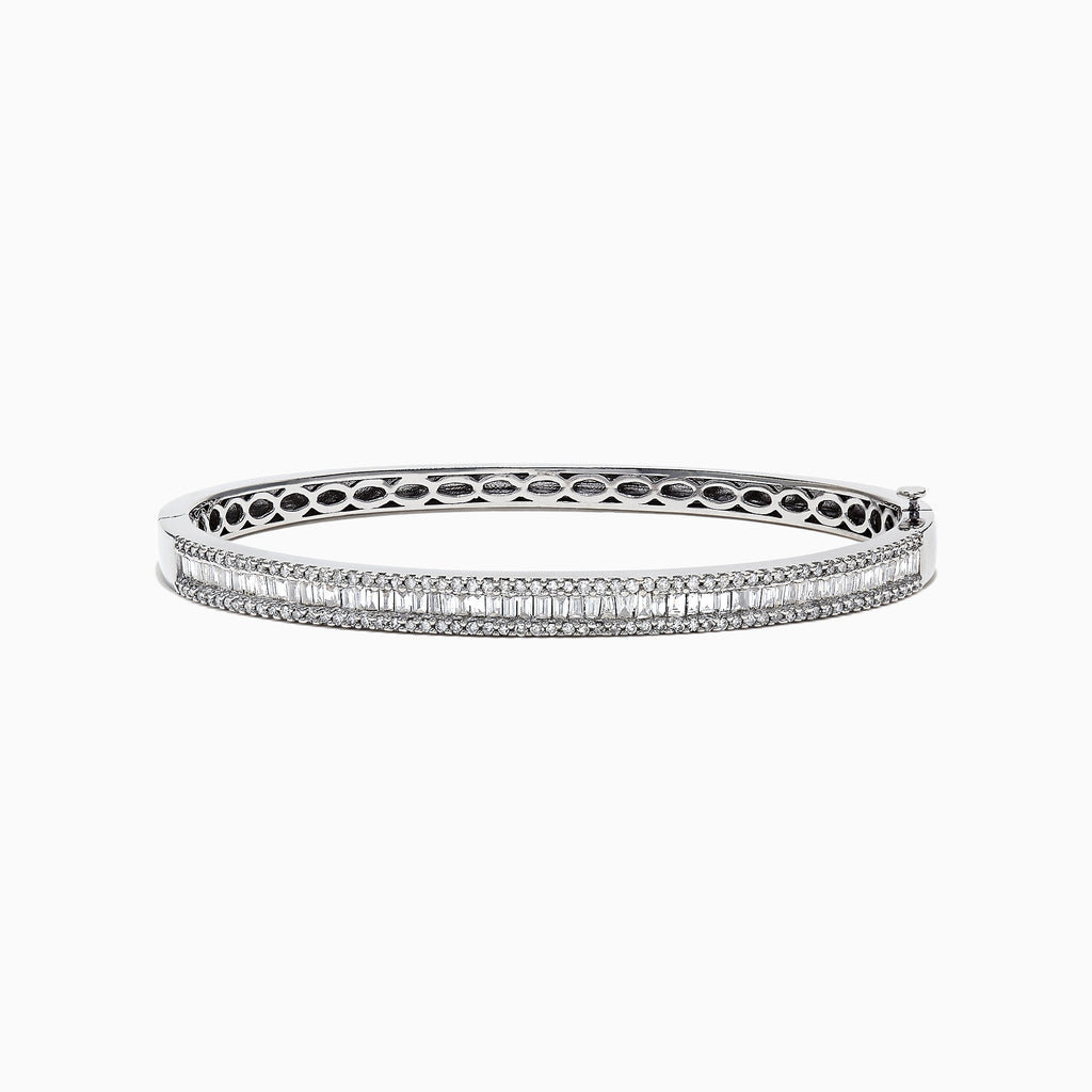 The Classique 14K White Gold Diamond Bangle 1.22 TCW features two rows of round diamonds, a central row of vertically set baguette-cut diamonds, and an openwork inner band design.