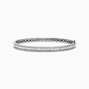 The Classique 14K White Gold Diamond Bangle 1.22 TCW features two rows of round diamonds, a central row of vertically set baguette-cut diamonds, and an openwork inner band design.
