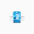 The Ocean Bleu 14K White Gold Blue Topaz and Diamond Ring, 8.06 TCW, showcases a large rectangular blue topaz center with sparkling diamonds along the band, displayed on a plain white background.