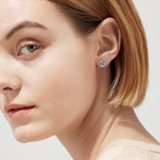 Ocean Bleu 14K White Gold Blue Topaz Stud Earrings, 1.10 TCW, feature brilliant round blue gemstones in sleek white gold bezels and are shown on a white background.