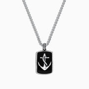 The Mens Sterling Silver Onyx Anchor Dog Tag Pendant, 18.85 TCW, features a rectangular onyx center with a raised silver anchor and rope-like border, creating a bold and striking accessory for men.
