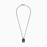 The Mens Sterling Silver Onyx Anchor Dog Tag Pendant, 18.85 TCW, features a rectangular onyx center with a raised silver anchor and rope-like border, creating a bold and striking accessory for men.