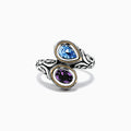 The 925 Sterling Silver & 18K Gold Topaz and Amethyst Ring, 1.62 TCW, features ornate patterns and two teardrop gemstones—blue topaz and purple amethyst—set side by side in gold-edged bezels on a white background.