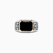 The Mens Sterling Silver and 14K Yellow Gold Onyx Ring, 3.40 TCW features a rectangular black onyx stone in a yellow gold bezel with detailed Celtic knot designs on the sides.