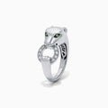 The Signature Sterling Silver Diamond and Tsavorite Panther Ring, 0.13 TCW, features green gemstone eyes and a diamond-studded ring in its mouth. Displayed on a plain white background.