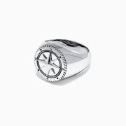 The Mens Sterling Silver Compass Ring showcases a detailed star at the center and engraved directional markers (N, E, S, W) around the edge. Its striking design is highlighted against a plain white background.