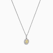 The Canare 18K Two-Tone Gold Oval Yellow Diamond Pendant (0.46 TCW) features a vivid yellow diamond encircled by sparkling stones, blending timeless elegance with modern design.