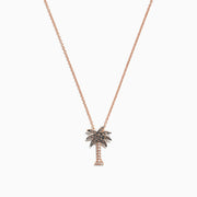 A Novelty 14K Rose Gold Diamond Palm Tree Pendant (0.10 TCW) necklace is shown on a delicate chain, with sparkling stones, displayed against a white background.