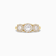The Bouquet 14K Yellow Gold Three-Stone Diamond Halo Ring, 1.01 TCW, showcases three round diamonds with sparkling halos set in a thick gold band, displayed on a plain white background.