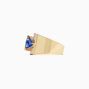 The Nahla Siri 14K yellow gold ring features a 0.74 TCW off-center triangular tanzanite and a vertical row of five round white diamonds, shown on a plain white background.