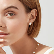 The 14K Yellow Gold Fresh Water Cultured Pearl Stud Earrings feature round white pearls on yellow gold posts with butterfly backs, shown on a white background.