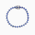 The Nahla Siri Sterling Silver Tanzanite Tennis Bracelet, 11.40 TCW, features a circle of evenly spaced triangular tanzanite gemstones and is finished with a secure clasp.