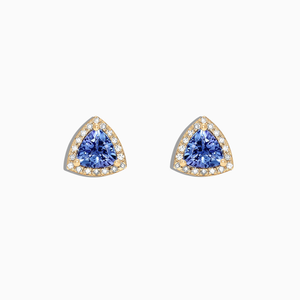 A pair of Nahla Siri 14K Yellow Gold Tanzanite and Diamond Stud Earrings, 1.19 TCW, featuring triangular blue stones surrounded by diamonds, is displayed on a white background.