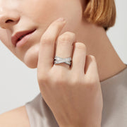 The Classique 14K White Gold Diamond Criss Cross Ring, 0.95 TCW, features baguette-cut and round diamonds in an elegant X-shape design, beautifully showcased on a plain white background.