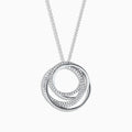 The Pave Classica 14K White Gold Diamond Pendant (0.41 TCW) features intertwined circles adorned with sparkling diamonds, elegantly suspended from a delicate chain against a white background.