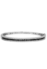 The 14K White Gold Black and White Diamond Bangle, 2.13 TCW, features a sleek row of round black and white diamonds set along the center, shown against a white background.